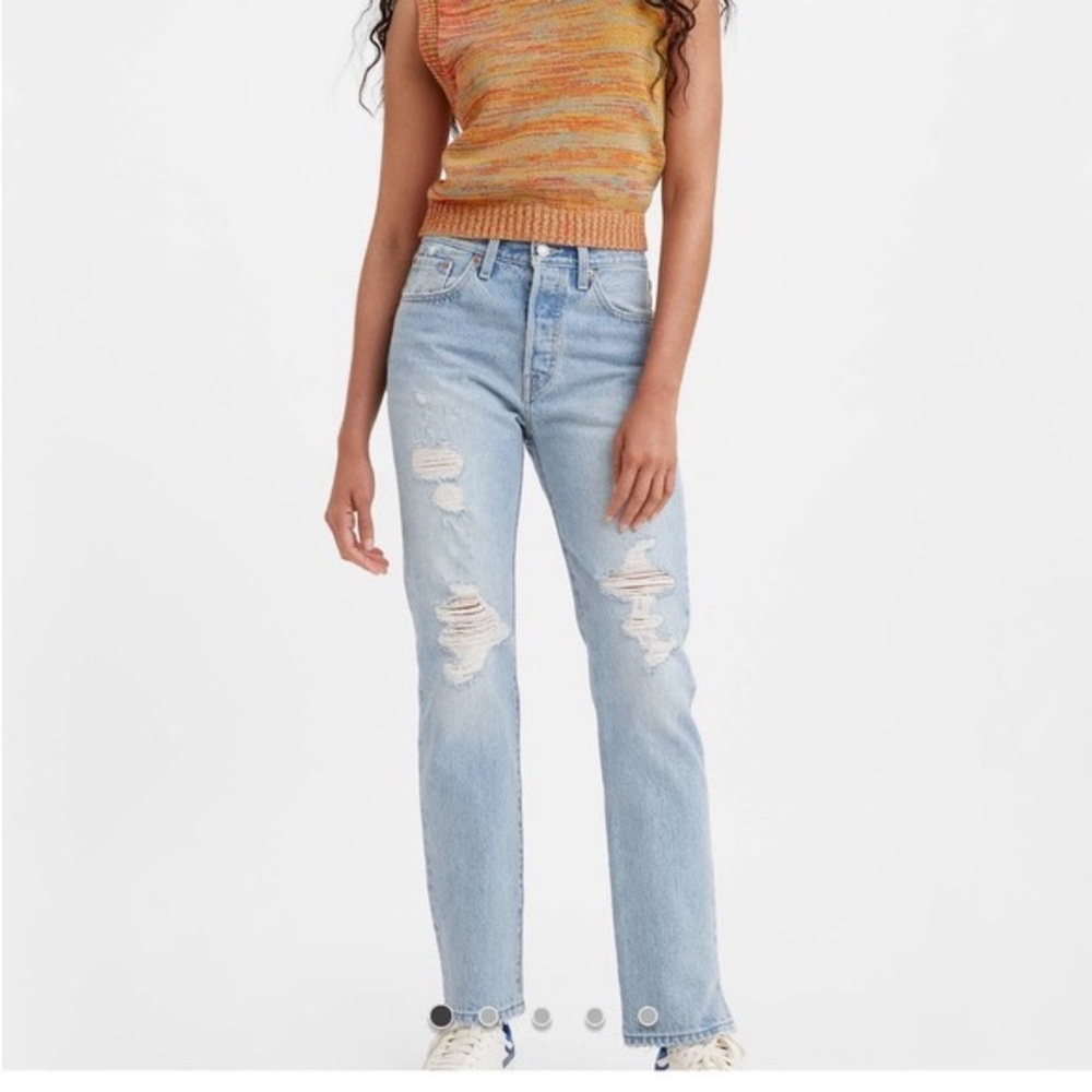Brand new with tags Levi’s 501 original in a light wash with distressing.